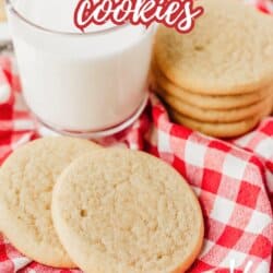 A stack of snickerdoodle cookies and two cookies in front sit on a red and white checkered cloth next to a glass of milk. Text reads Snickerdoodle cookies and So easy.