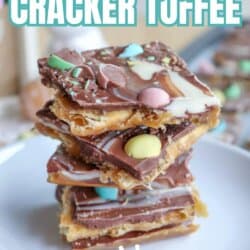 A stack of chocolate-covered cracker toffee topped with colorful mini Easter eggs is displayed on a plate. Text on the image reads โMini Egg Cracker Toffee,โ โSo Easy,โ and โhomemadeheather.com.โ.