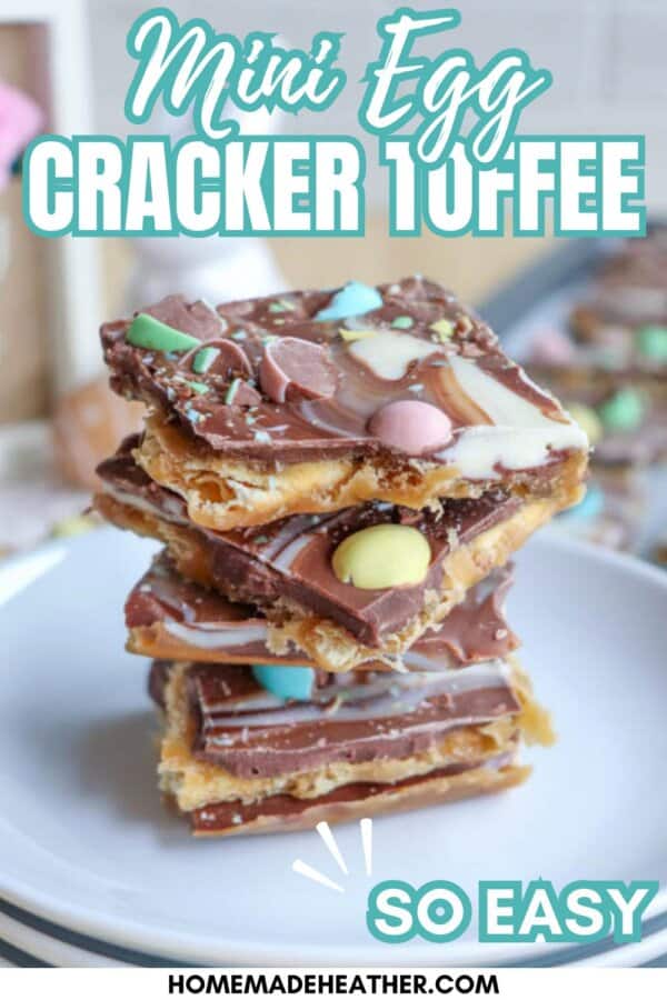 A stack of chocolate-covered cracker toffee topped with colorful mini Easter eggs is displayed on a plate. Text on the image reads โMini Egg Cracker Toffee,โ โSo Easy,โ and โhomemadeheather.com.โ.