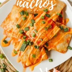 A plate of crispy crab rangoon nachos topped with orange sauce and chopped green onions, with text reading Crab Rangoon Nachos and So Good! at the bottom. Website: homemadeheather.com.