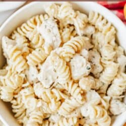 A bowl of creamy rotini pasta with chunks of chicken, topped with herbs. Text reads: one pot chicken Boursin pasta and homemadeheather.com at the bottom.