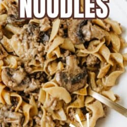 A plate of beef and mushroom noodles made with wide egg noodles, ground beef, and mushrooms in a creamy sauce. Text overlay reads: โbeef & mushroom NOODLES, TikTok recipe, homemadeheather.com.โ.