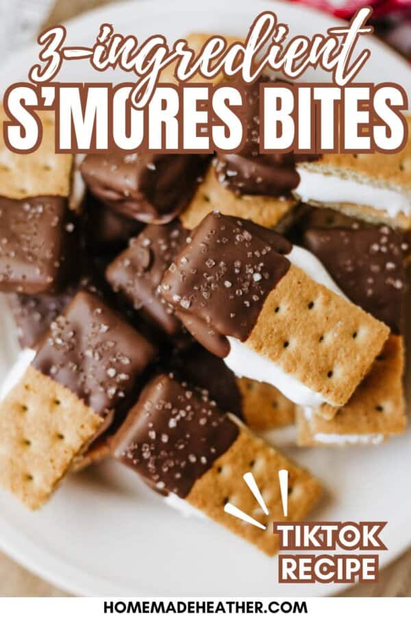 A plate of s’mores bites made with graham crackers, chocolate, and marshmallow, arranged in a pile. Text reads 3-ingredient S’mores Bites and TikTok Recipe with the website homemadetheather.com at the bottom.