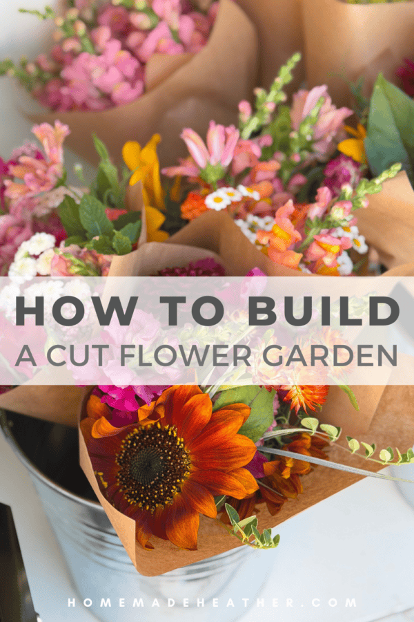 A variety of colorful cut flowers in brown paper wraps are displayed in a metal bucket. Text overlay reads, โHow to Build a Cut Flower Gardenโ with a website link at the bottom.